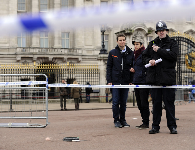 An area is cordoned off Sunday outside Buckingham Palace in London after police used a stun gun to subdue a man armed with two knives. Queen Elizabeth II and Prince Philip were not at the palace at the time.