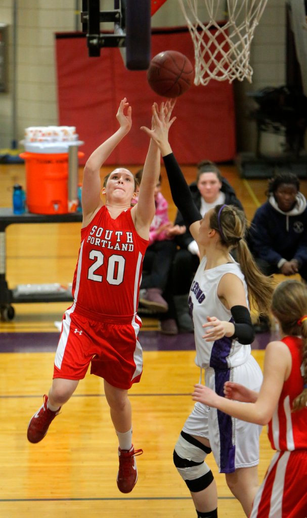 Meaghan Doyle of South Portland puts up a shot past Deering’s Marissa MacMillan Monday night. Deering won with its defense, 33-21.