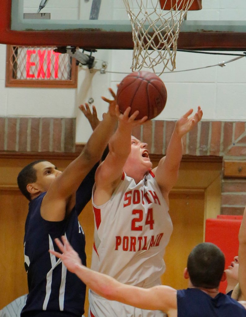 Conner MacVane of South Portland spins to put up a shot while guarded by Matt Talbot of Portland during South Portland’s 52-42 victory Tuesday night.