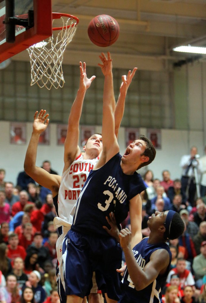 Nate Smart of Portland attempts to tip the ball in Tuesday night over Jack Toland of South Portland during the first quarter of South Portland’s 52-42 victory at home.