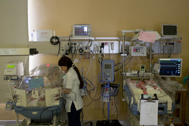 A Palestinian nurse at the Holy Family Hospital in the West Bank town of Bethlehem takes care of a newborn baby. The hospital is one of many run by the Sovereign Military Order of Malta, an ancient Roman Catholic religious order.