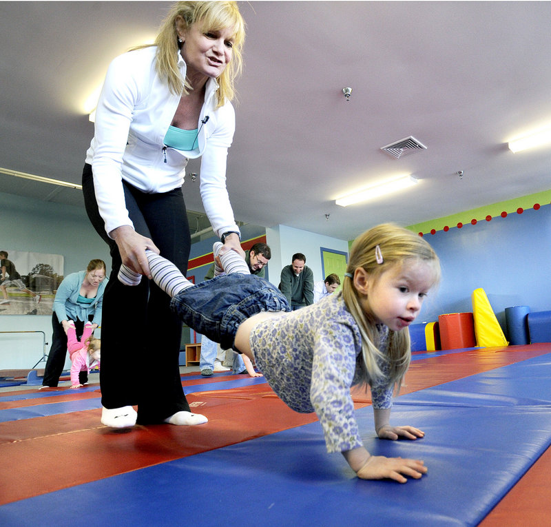 Kim DeMado conducts an exercise class in March 2012 with then-3-year-old Rachael Cohen from Cumberland and other toddlers and parents at Tumble Tikes Children’s Fitness Center in Portland. DeMado and her husband, Tim, launched the center after becoming parents in 2009.