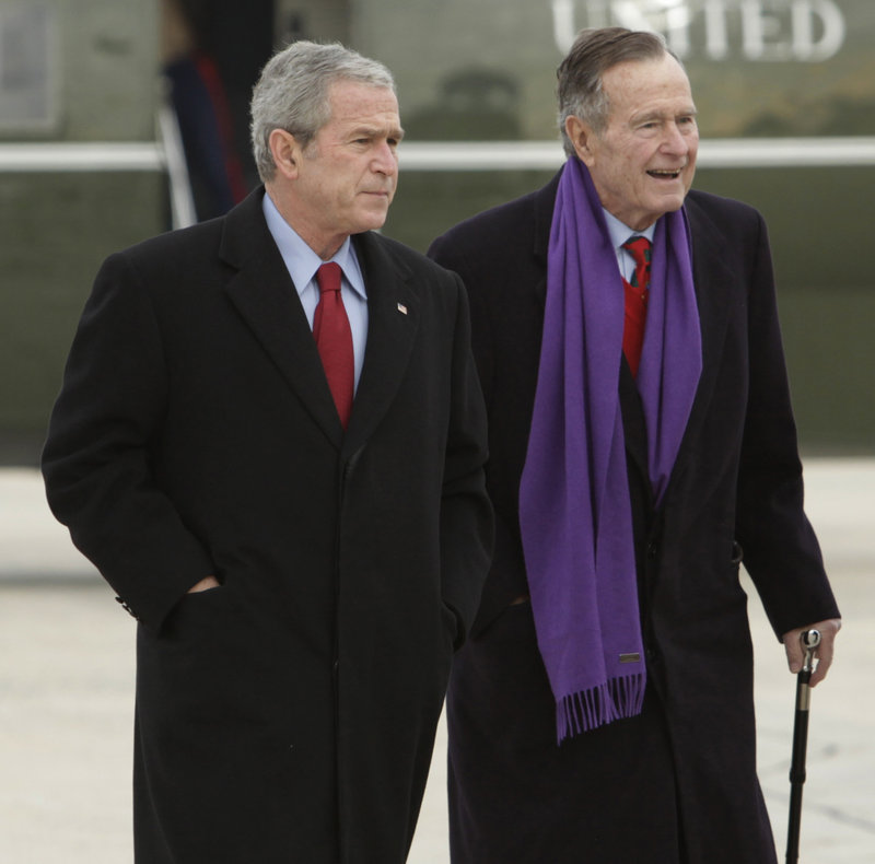 President George W. Bush walks with his father, former President George H.W. Bush, at Andrews Air Force Base, Md., in 2008.