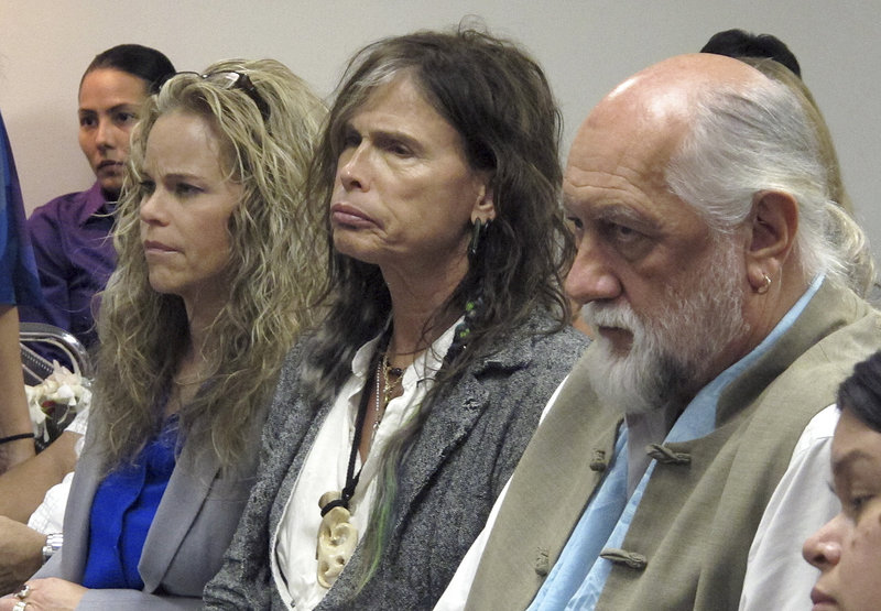 Aerosmith lead singer Steven Tyler, center, sits with Fleetwood Mac drummer Mick Fleetwood, right, as they listen to testimony on a celebrity privacy bill.