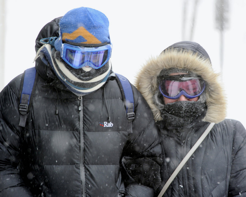 Scarves and goggles were popular Saturday as Kevin Phillips and Katie Nimmo keep their heads down into the wind as they search for an open pub in the Old Port in Portland during the Blizzard of 2013.