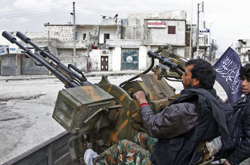 Free Syrian Army fighters sit behind their anti-aircraft weapon in Aleppo, Syria, on Friday, as rebels brought their fight within a mile of the heart of Damascus.