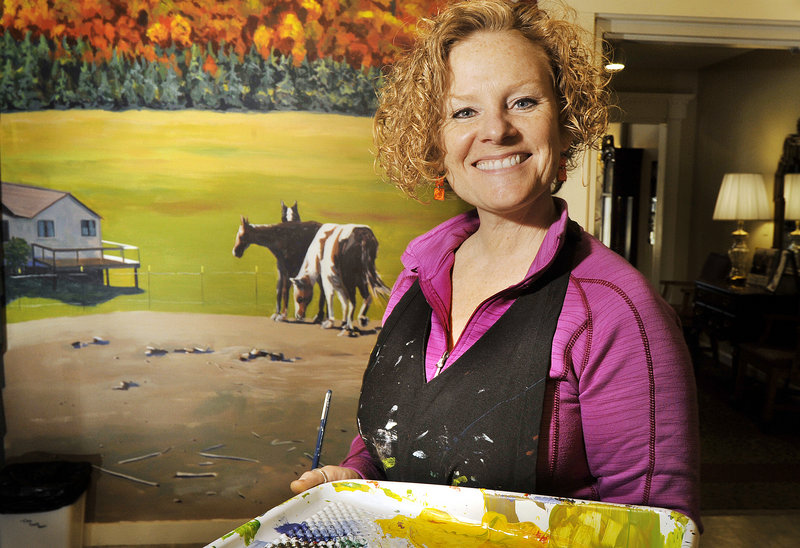 South Portland artist Francine Schrock works on a section of the mural she is creating at an Auburn retirement community, where the residents provide much advice.