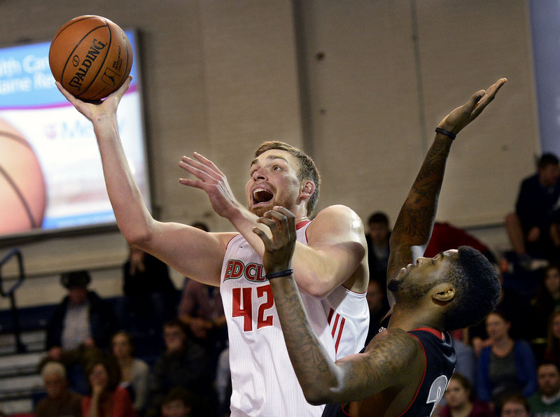 Garrett Stutz of the Red Claws goes up for a shot as Springfield’s Willie Reed defends Sunday at the Expo. Stutz was one of five players who scored in double figures for Maine in a 104-100 victory.