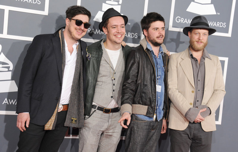 From left, Marcus Mumford, Ben Lovett, Country Winston and Ted Dwane of Mumford & Sons arrive at the Grammy Awards on Sunday. Even the London folk-rockers themselves – stars of the 2012 Gentlemen of the Road Stopover in Portland – were surprised when their “Babel” won album of the year.
