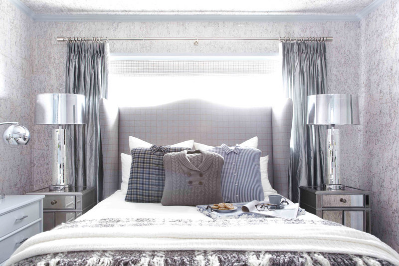 This guest bedroom designed by Brian Patrick Flynn includes a custom headboard made from men’s suiting fabric and pillows made from hand-me-down sweaters and flannel shirts.