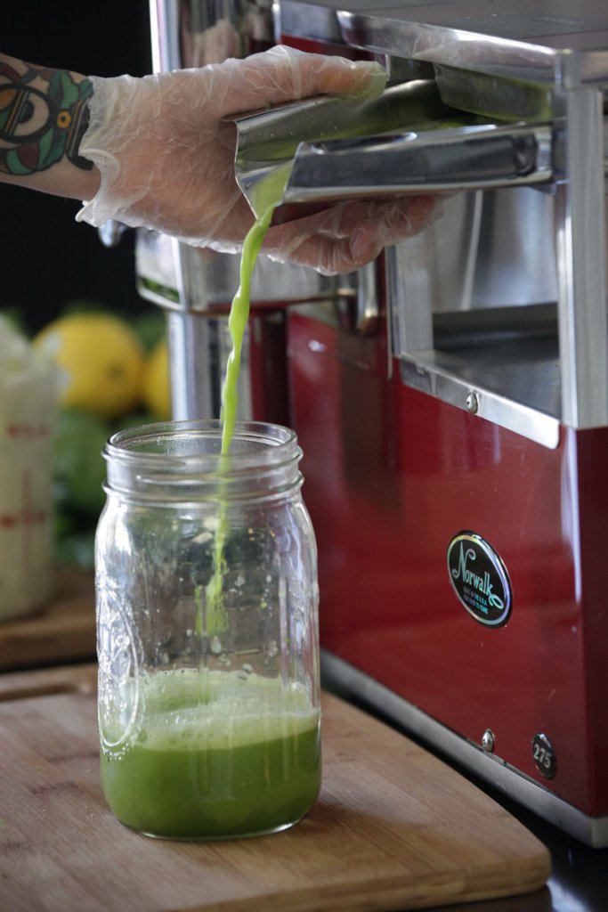 An employee creates a green juice at Drought in Plymouth, Mich., where juices are made to order in small batches.