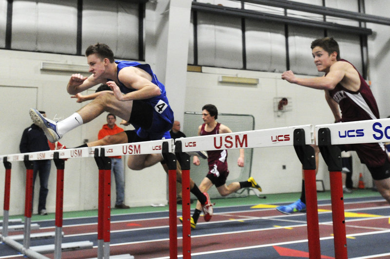 Tom Reid of York clears a hurdle on his way to victory in the 55-meter hurdles. Reid finished in 8.5 seconds.