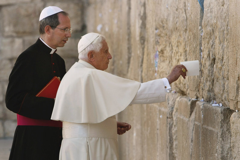 Pope Benedict XVI places a note in the Western Wall, Judaism’s holiest site, in Jerusalem’s Old City in 2009.