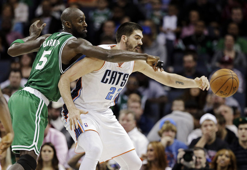 Boston Celtics' Kevin Garnett fouls Charlotte Bobcats' Byron Mullens during the second half of an NBA basketball game in Charlotte, N.C., Monday. The Bobcats won 94-91.