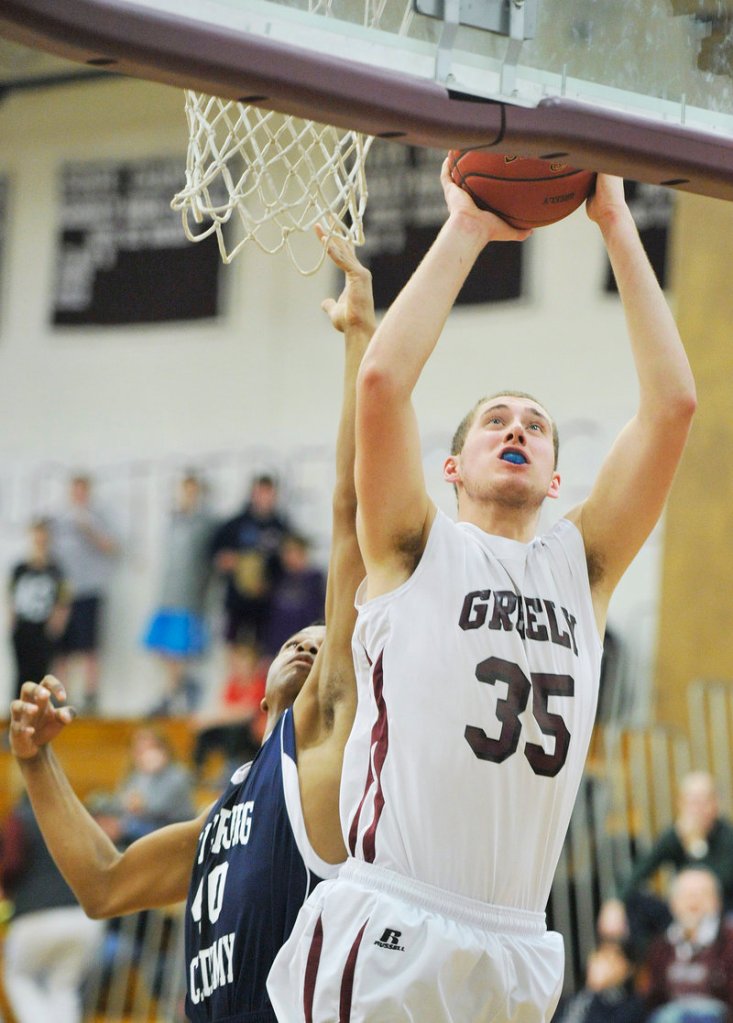 Greely’s Michael McDevitt slips past Fryeburg’s Jaquan Causer for two of his game-high 27 points during Tuesday’s 71-51 victory.