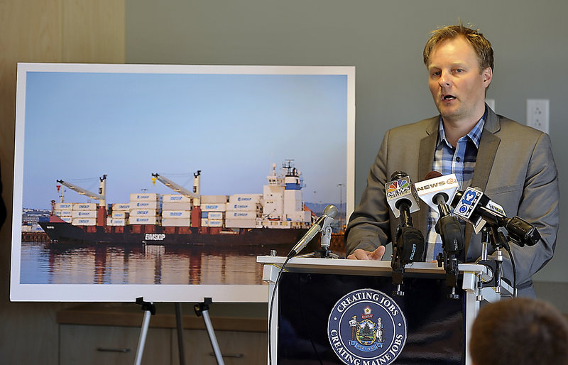 Standing with a picture of an Eimskip operation, General Manager Larus Isfeld talks to the media Wednesday about coming to Portland.