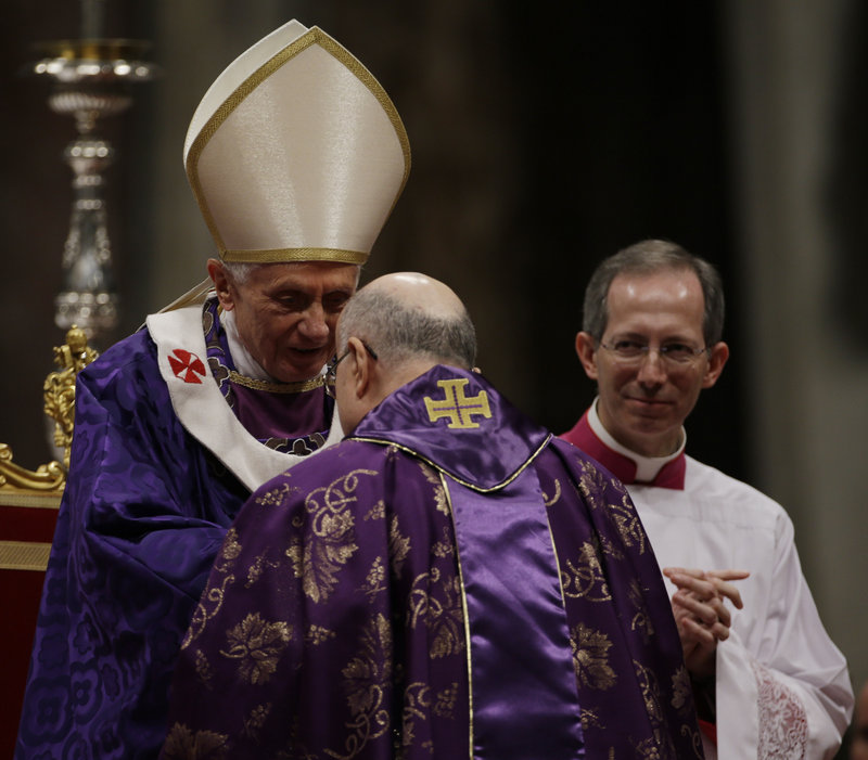 Vatican Secretary of State Cardinal Tarcisio Bertone greets Pope Benedict XVI at the end of the Ash Wednesday Mass in St. Peter’s Basilica at the Vatican.