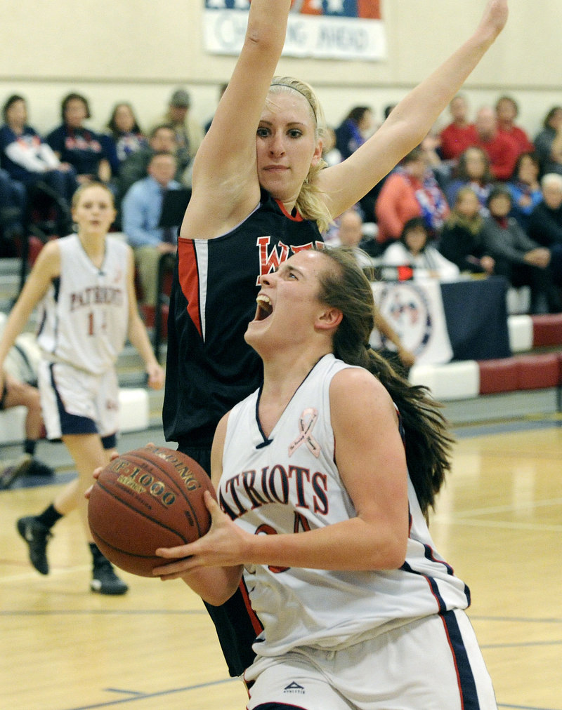 Maria Valente of Gray-New Gloucester concentrates on the basket Wednesday night while driving against Alison Furness of Wells during their Western Class B prelim. Wells won 53-46 and will meet Spruce Mountain in a quarterfinal.
