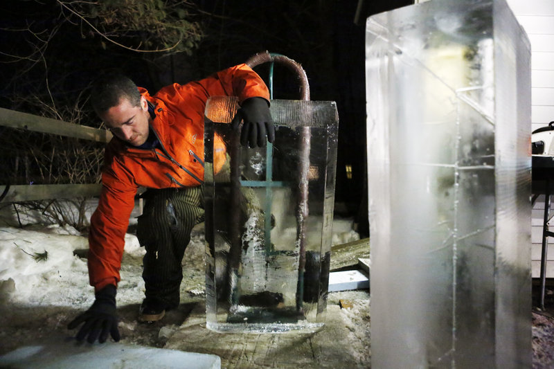 Ice sculptor Jesse Bouchard reaches for a piece of foam to put behind a block of ice on a handtruck that he will wheel back into his freezer at his South Portland home on Tuesday, February 12, 2013. The ice blocks will be made into an ice bar for the Hilton Garden Inn in Freeport on Friday night.
