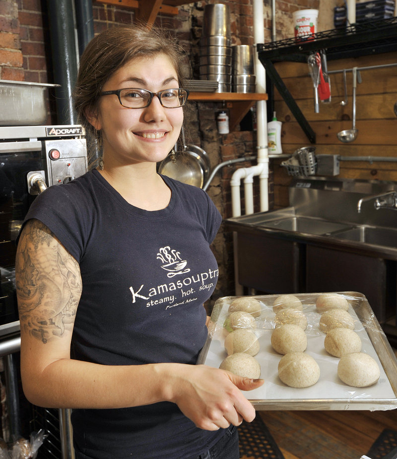 Colleen Callahan, manager of Kamasouptra, a soup shop in Portland's Public Market, prepares rolls for baking on Thursday afternoon. She supports President Obama's proposal to raise the minimum wage to $9 an hour. "I think it should be $12 an hour. You can't do anything on minimum wage," Callahan says.
