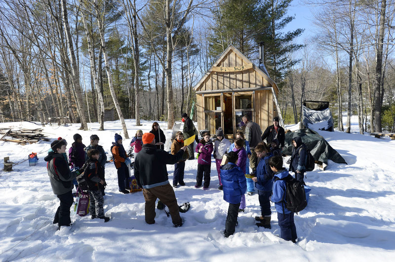 Teacher Glenn Powers lectures students by the warming hut at the Hidden Valley Nature Center in Jefferson as part of the curriculum of the “40 Days in the Woods” program.