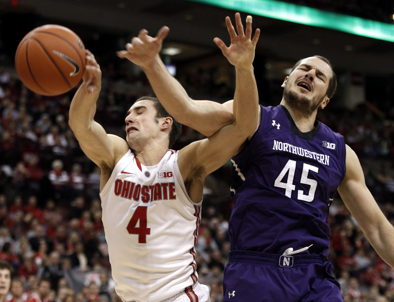 Aaron Craft of Ohio State holds off Nikola Cerina of Northwestern and chases down a rebound Thursday night during Ohio State’s 69-59 victory at home.