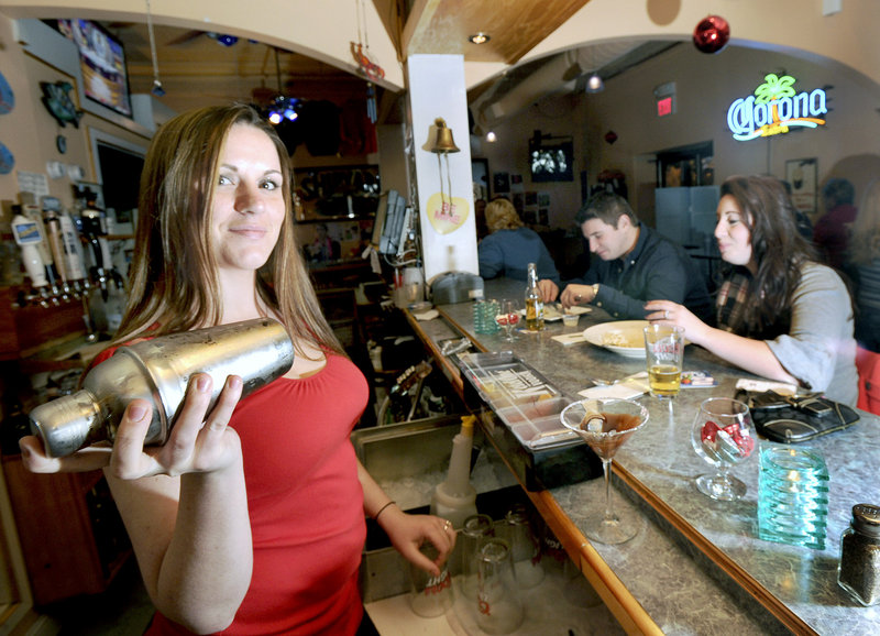 JJ’s Eatery Too bartender Kristen Keenan shakes a “chocolate-covered pretzel martini” while Sam Maddams and Lauryn Goyet dine at the bar in Old Orchard Beach.
