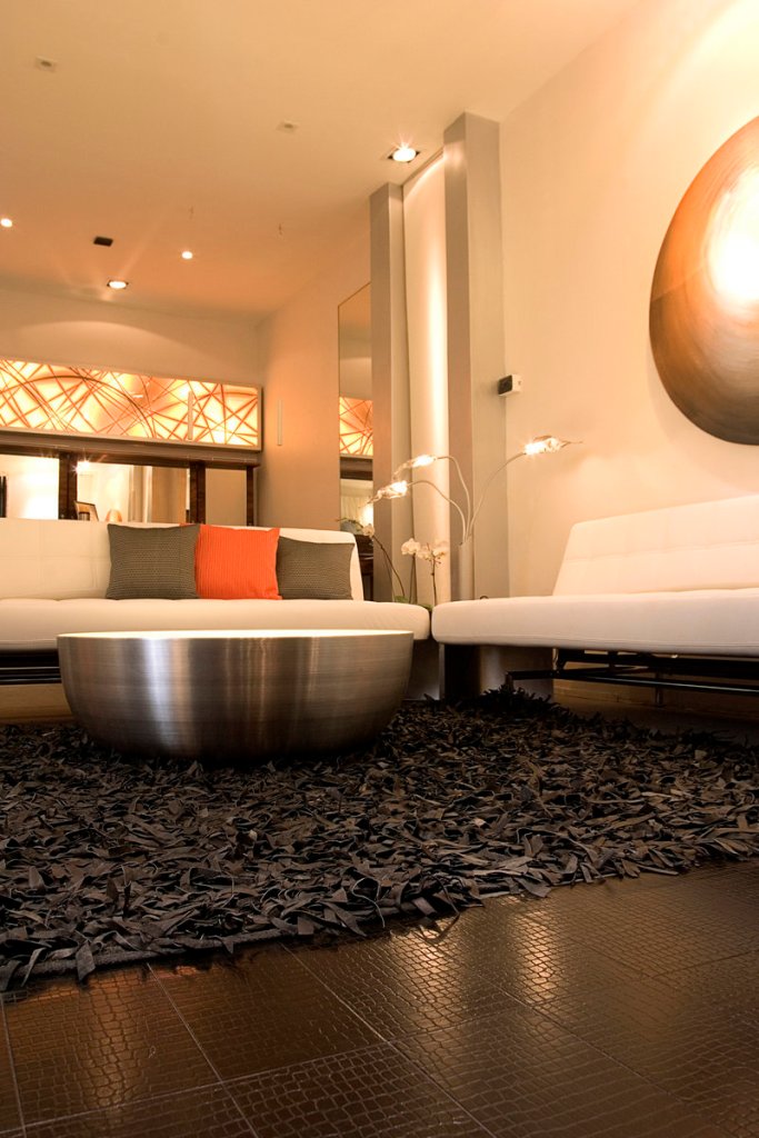 Flooring made of recycled leather boosts the modern look in this edgy living space.