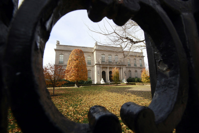 Rhe Elms mansion in Newport, R.I., seen through an opening in an iron fence.