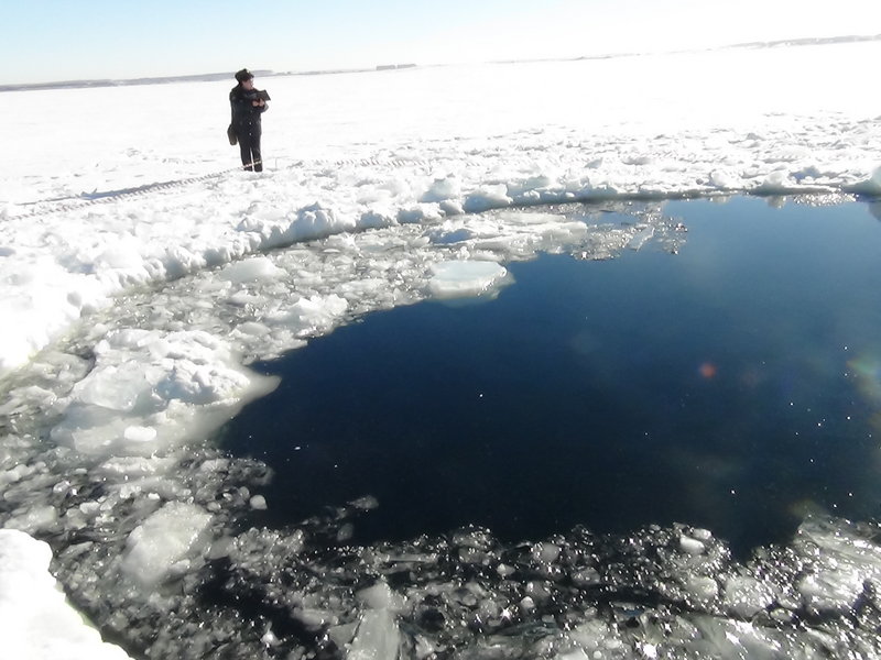 A hole in the ice of Chebarkul Lake indicates where the space rock may have struck Earth.