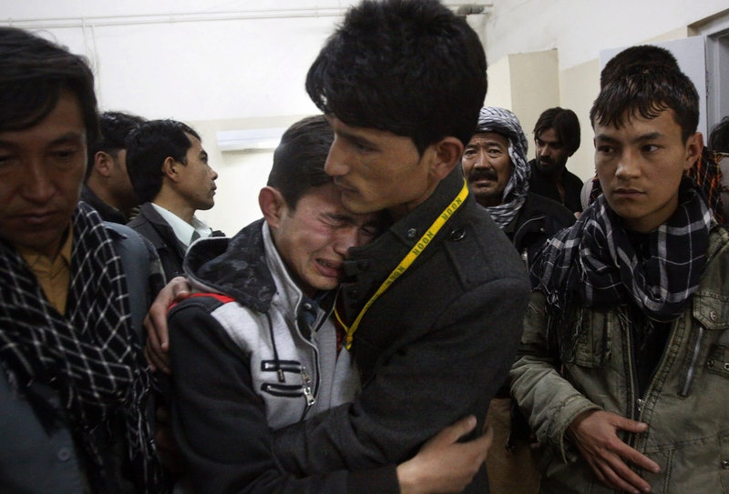 A Pakistani man comforts another mourning for a family member who died in a bomb blast in a Shiite Muslim-dominated suburb of the city of Quetta on Saturday.