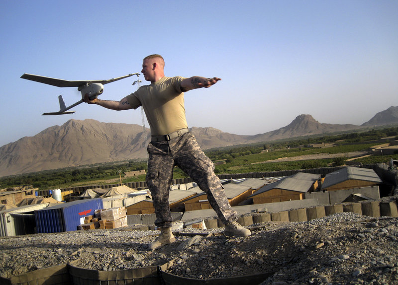 Pfc. Joseph Robinson of Eugene, Ore., launches a “Raven,” an unmanned reconnaissance drone, at Combat Outpost Senjeray, Kandahar province, Afghanistan, on Sept. 11, 2010.