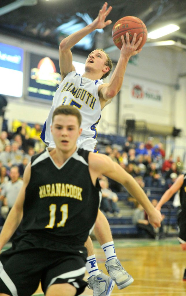 Falmouth's Grant Burfeind goes strong to the basket against Taylor Wilbur during the top-ranked Yachtsmen's 58-30 win over Maranacook at the Portland Expo.
