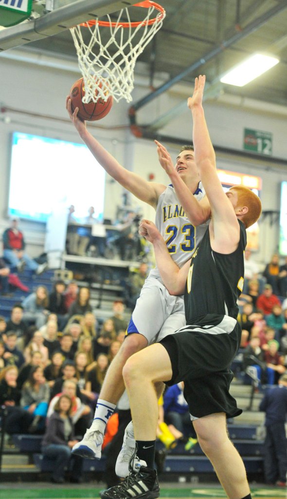Jack Simonds of Falmouth gets his layup swatted away by Kyle Boucher of Maranacook.