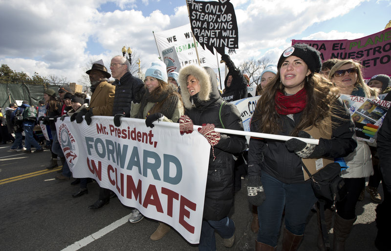 From center to right, Bill McKibben (wearing glasses), Fiona McRaith, Leah Qusba and Maayan Cohen join a march from the National Mall to the White House on Sunday during a rally calling on President Obama to reject the Keystone XL oil pipeline from Canada.