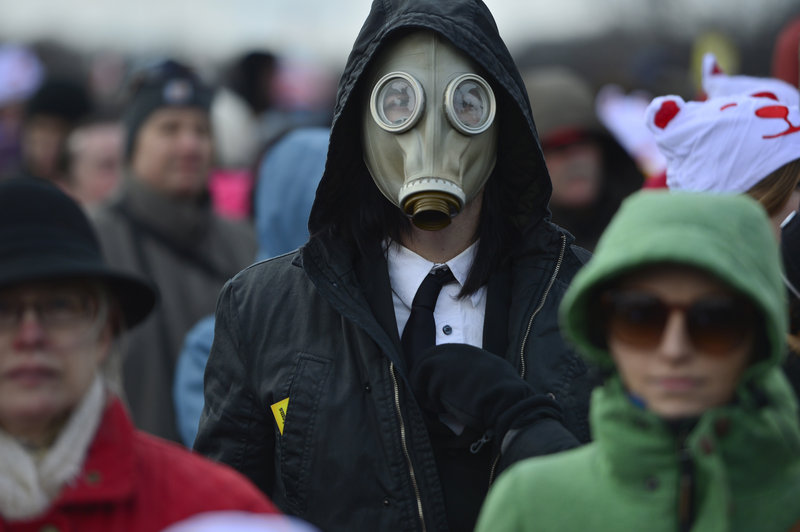 A man wearing a gas mask joins the crowd gathered Sunday on the National Mall in Washington for the “Forward on Climate” rally.