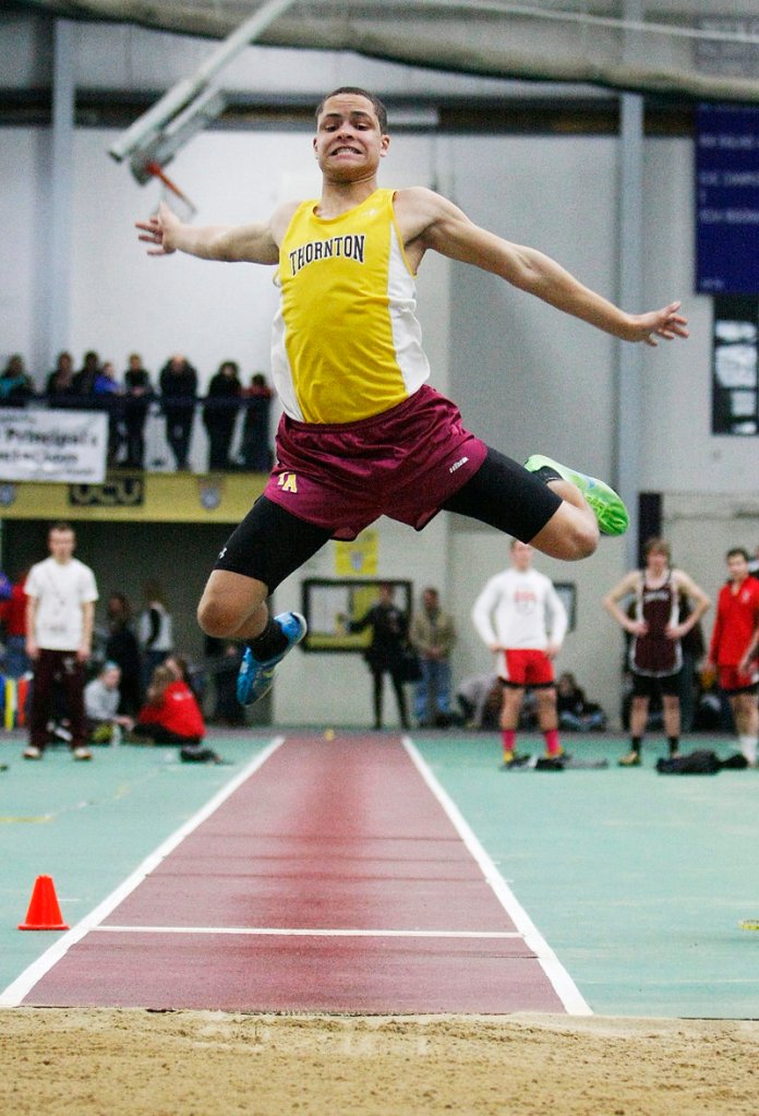 Andrew Smith of Thornton Academy gets plenty of air time while competing in the Class A long jump. Smith finished second with a jump of 20 feet, 4 inches.