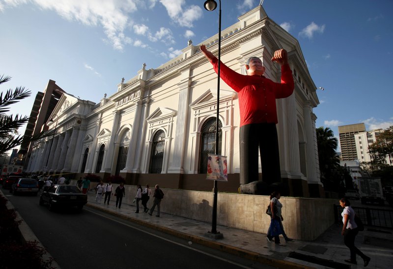 An inflatable doll depicting Venezuela’s President Hugo Chavez occupies the front of the National Assembly in Caracas on Monday. Chavez announced his return on Twitter.