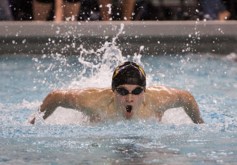 Trebor Lawton of Cheverus churns his way to victory in the 100-yard butterfly at the Class A state championships Monday at Bowdoin College.