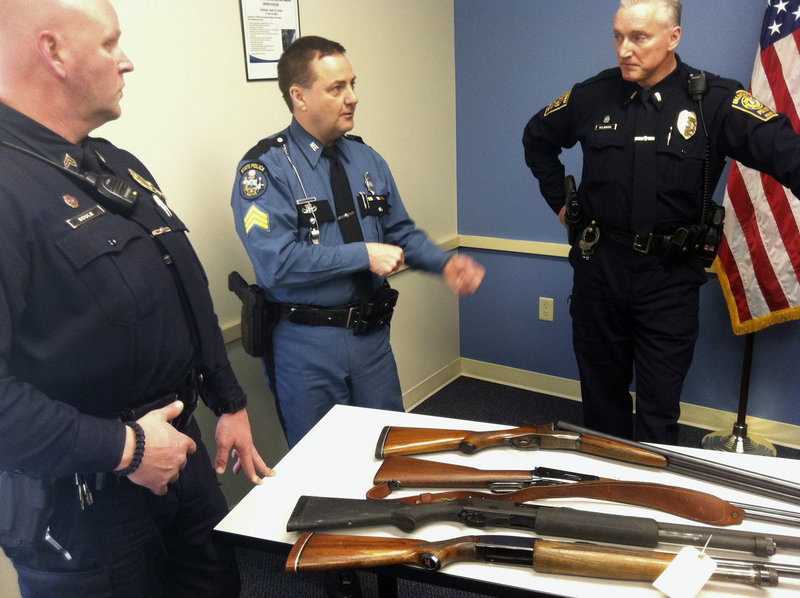 Maine State Police Sgt. Michael Edes (center), talks about a new gun donation program Tuesday, February 19, 2013, with Falmouth Police Sgt. Franke Soule (left) and Falmouth Police Lt. John Kilbride. On the table is a collection of guns that people have turned into the public over the past year, including a Winchester 12 gauge shotgun that was donated to the Cumberland Police Department on Monday.