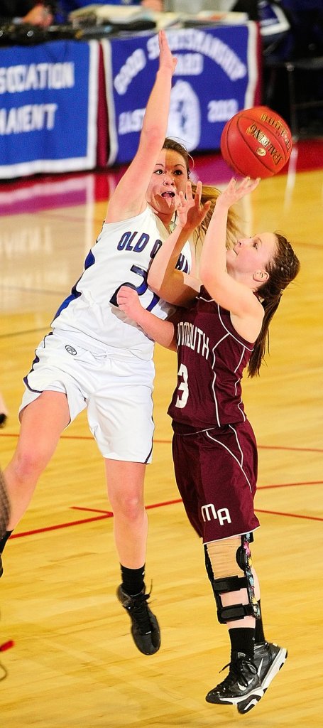 Ashley Coulombe, right, of Monmouth Academy attempts to get a shot past Abby Dubois of Old Orchard Beach during OOB's 63-57 victory in Augusta.