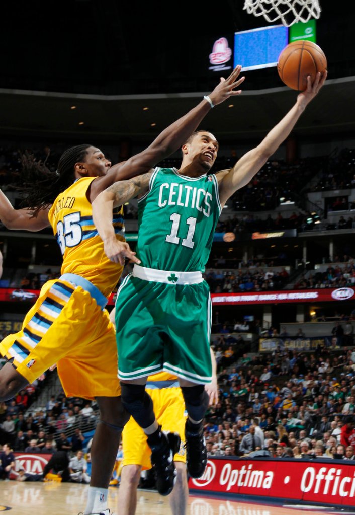 Celtics guard Courtney Lee drives the lane for two points despite tenacious defense from Nuggets forward Kenneth Faried during Tuesday’s game in Denver.