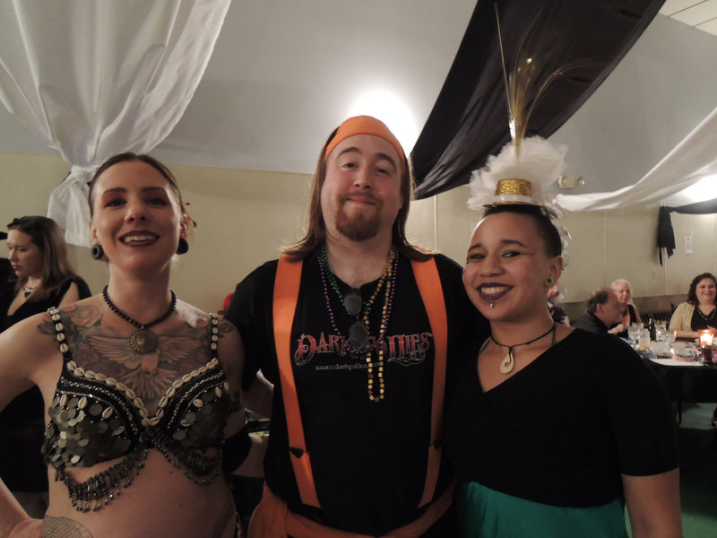 A lighter moment for members of the street performance group Dark Follies: Kait Pressey (stage name Kait-Ma), Bryan Burns (stage name Scavenger), and Rosa Libby (stage name Rosa May). This is the third year Dark Follies has donated its performance at the Mardi Gras Ball.