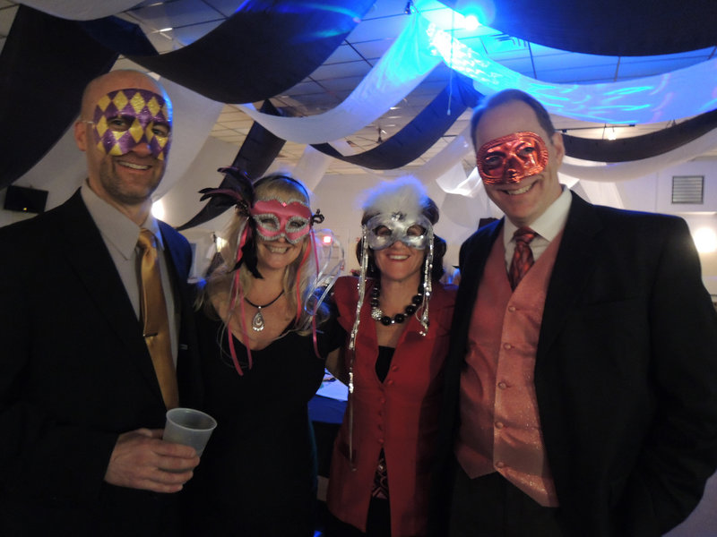 Embracing the evening’s theme are Greg Patterson of Kennebunk, Heather Lynch of Gorham, Amy Safford, director of development for Community Partners, and her husband, Jon Safford of Kennebunk.