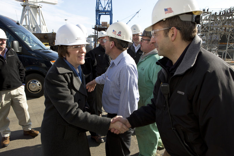 U.S. Sen. Susan Collins greets Bath Iron Works supervisor Chris Comora Thursday, Feb. 21, 2013, as she and Sen. Angus King toured the shipbuilding plant.