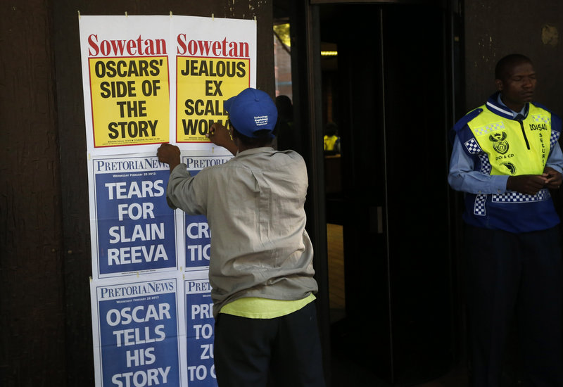 A newspaper vendor posts the headlines outside the courthouse in Pretoria, South Africa, where Oscar Pistorius has been appearing. The case is being followed closely both in South Africa and abroad.