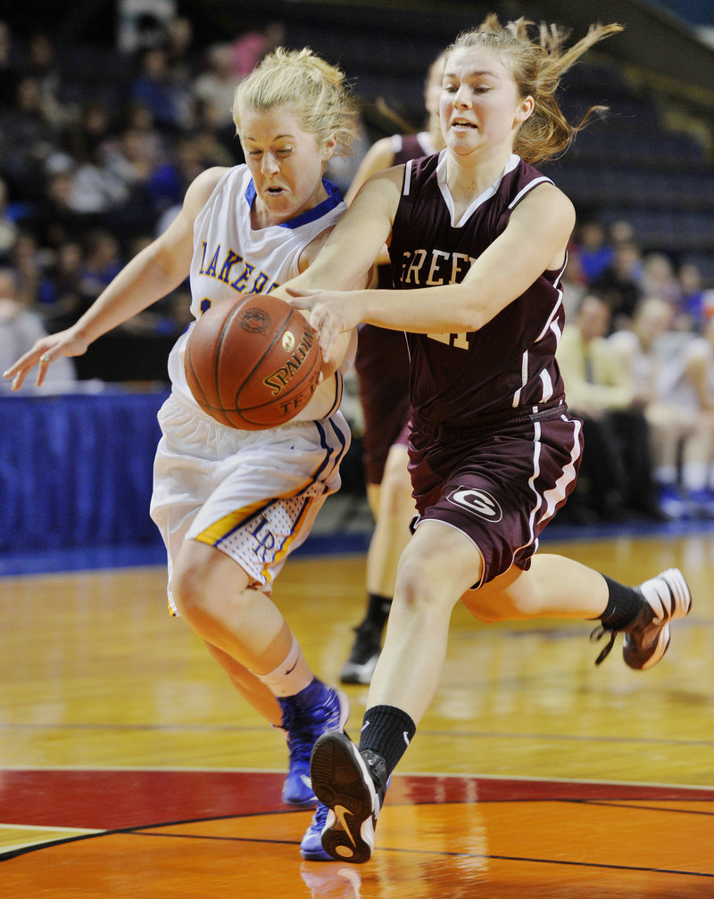 Sarah Hancock of Lake Region pokes the ball from Margaret Hatch of Greely to stop a breakaway layup during Lake Region's 42-27 win at the Civic Center.