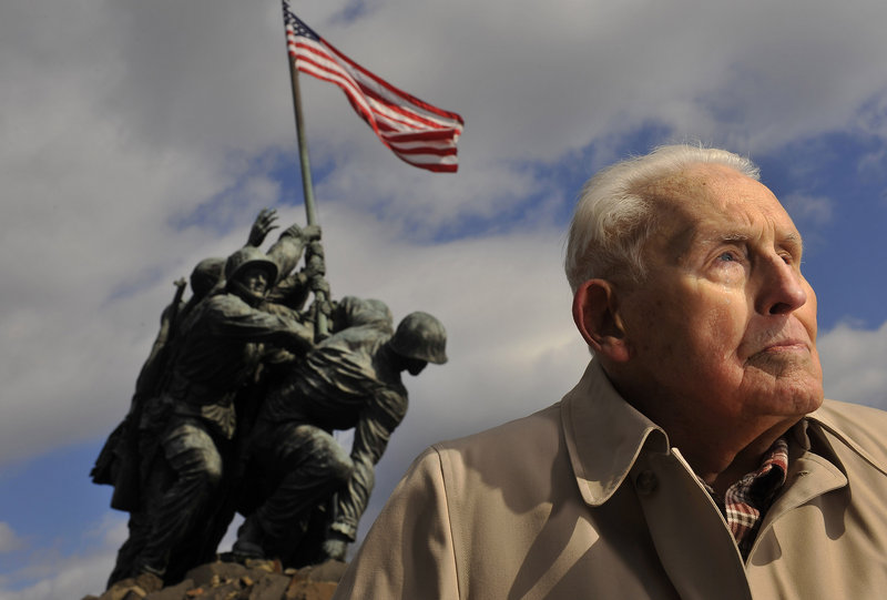 Norm Hatch, 91, poses for a portrait near the U.S. Marine Corps War Memorial, which is also referred to as the Iwo Jima Memorial, on Wednesday in Arlington, Va.