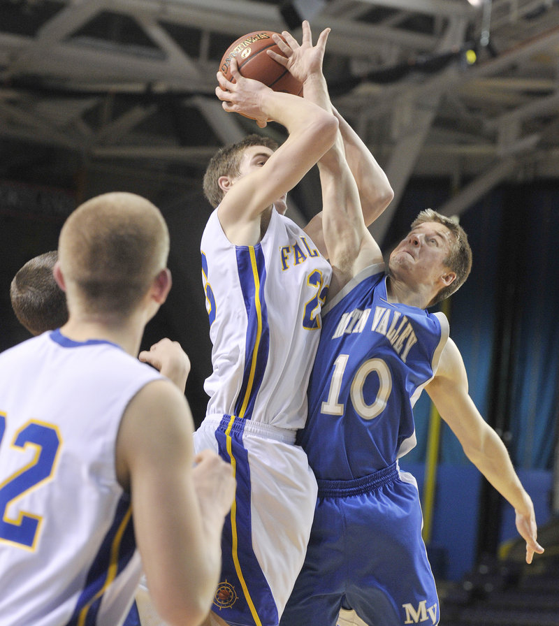 Charlie Fay of Falmouth is fouled by Adam Volkernick of Mountain Valley while going up for a shot. Fay scored 12 points for the Yachtsmen.