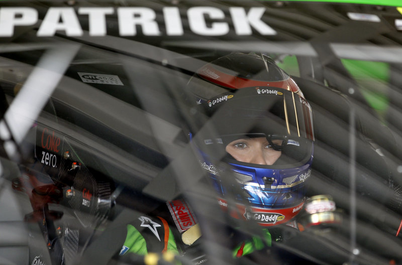Danica Patrick sits in her green car waiting to start a practice run Friday for Sunday’s Daytona 500 NASCAR Sprint Cup Series race at the Daytona International Speedway in Daytona, Fla.
